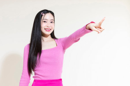 vintage y2k pink retro concept photo of korean asian cute woman with hand motionの写真素材