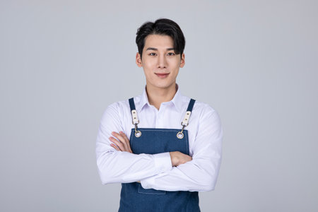 millennials and gen z, korean asian young man with crossed armsの写真素材