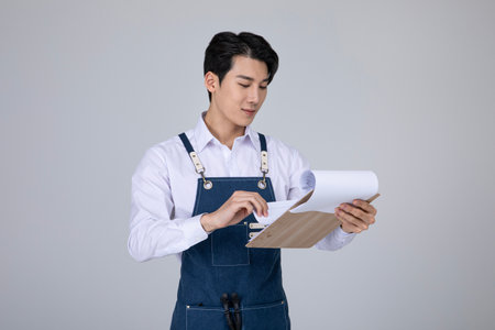 millennials and gen z, korean asian young man holding documentsの写真素材