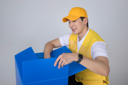 millennials and gen z, korean asian young man organizing moving boxes