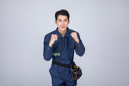 millennials and gen z, korean asian young man, site staff with hand motionの写真素材