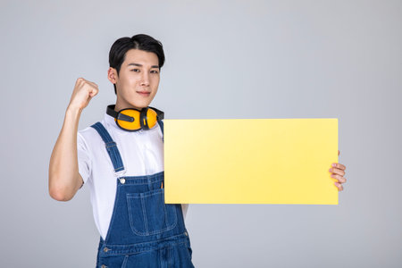 millennials and gen z, korean asian young man carpenter with a frame panelの写真素材