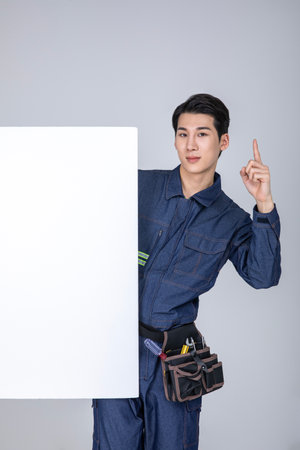 millennials and gen z, korean asian young man, site staff with a frame panelの写真素材