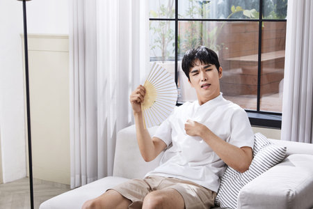 summer lifestyle, korean asian young man fanningの写真素材