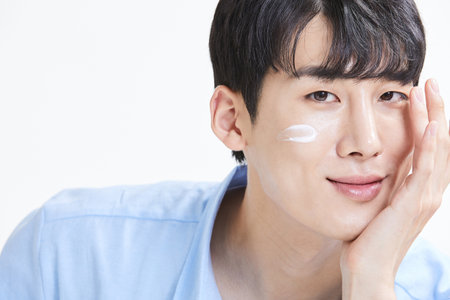 korean asian young man with skincare productsの写真素材
