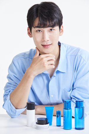 korean asian young man sitting in front of a vanityの写真素材