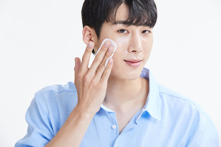 korean asian young man with skincare productsの写真素材