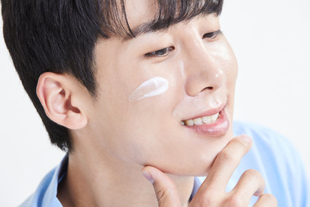 korean asian young man with skincare productsの写真素材