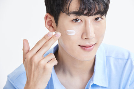korean asian young man with skincare productsの写真素材