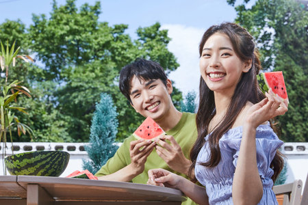 summer lifestyle, korean asian young couple with watermelonの写真素材