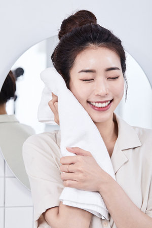 summer lifestyle, korean asian young woman drying face with a towelの写真素材