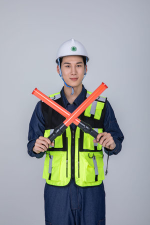 millennials and gen z, korean asian young man, site staff holding a traffic signal