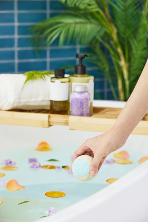 beauty concept photo of korean asain beautiful woman putting a bath bomb in a bathtub