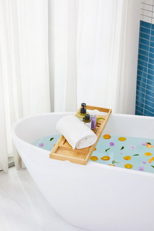 a bathtub with various bathing accessories, both productsの写真素材