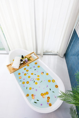 a bathtub with various bathing accessories, both products
