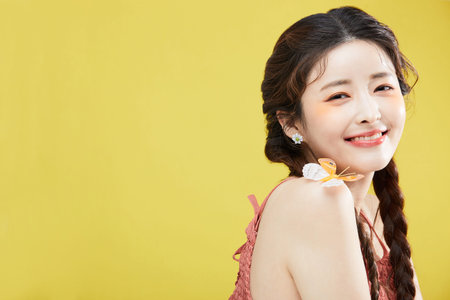 beauty concept photo of korean asain beautiful woman with a butterfly on her shoulder, smilingの写真素材