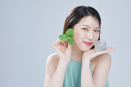 beauty concept photo of korean asain beautiful woman with cosmetic and a recycle bottleの写真素材