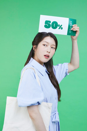 Greensumer_Coupons Image of a korean asain beautiful woman holding a coupon