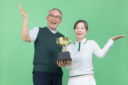 A senior holding a trophy
