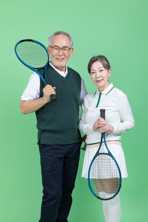 A senior with a tennis racketの写真素材