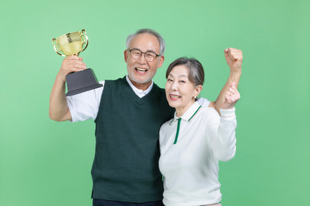 A senior holding a trophyの写真素材