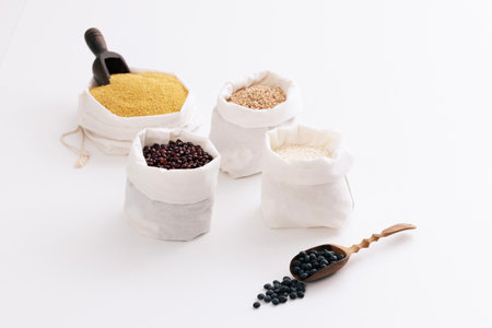 Grains for five grain rice are in small pockets and spoonsの写真素材