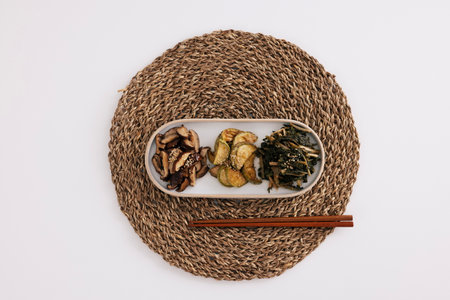 There are mushroom, pumpkin, and dried Siraegi leaf salad on the table matの写真素材