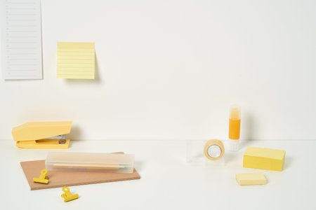 yellow office supplies on a white desk