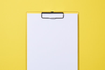 Clipboard with yellow backgroundの写真素材