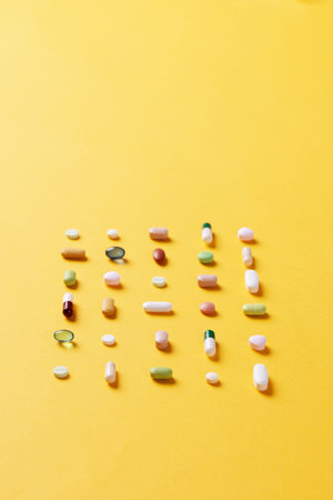 Color medicines arranged in a square shape on a yellow background