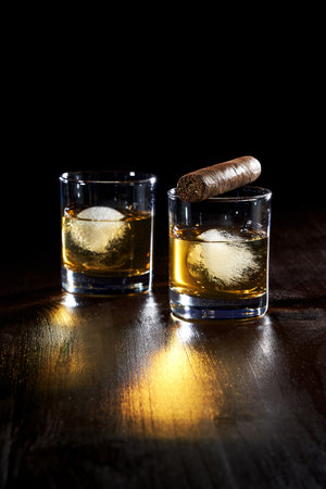 the composition of a glass of whiskey and cigar cigarettes with iceの写真素材
