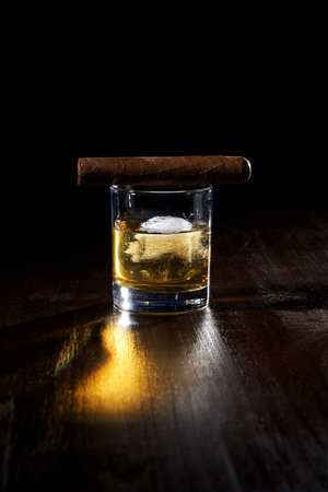 the composition of a glass of whiskey and cigar cigarettes with iceの写真素材