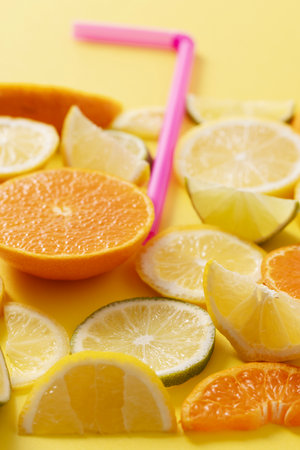 Citrus Fruit Pieces and Strawsの写真素材