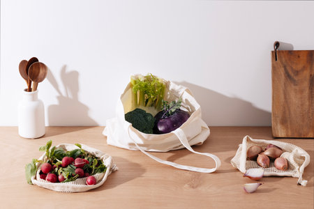 salad ingredients in net bags and eco bagsの写真素材