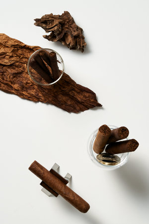 matches and cigars in a glass cup