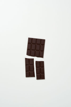 a piece of dark chocolate divided into three pieces