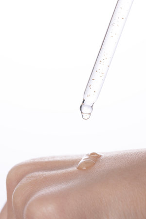a drop of moist ampoule on the back of the handの写真素材