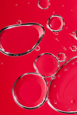 an image of water droplets enlarged against a red backgroundの写真素材