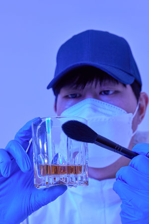 CSI Scientific Investigation Unit male researcher collecting fingerprints from crime scenes and...