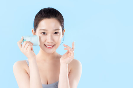 A teenage woman posing with cosmeticsの写真素材