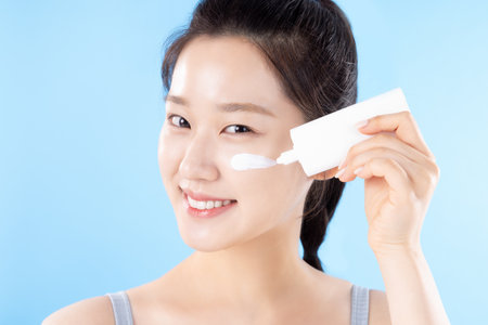 A teenage woman posing with cosmeticsの写真素材