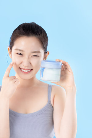 A teenage woman posing with cosmeticsの写真素材