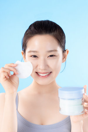 A teenage woman posing with cosmeticsの写真素材
