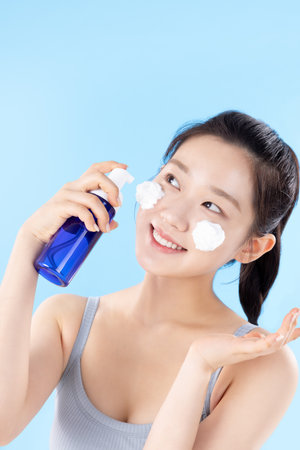A teenage woman posing with cosmeticsの写真素材