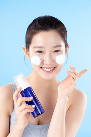A teenage woman posing with cosmeticsの写真素材