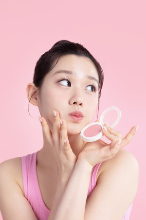 A teenage woman posing with cosmeticsの写真素材