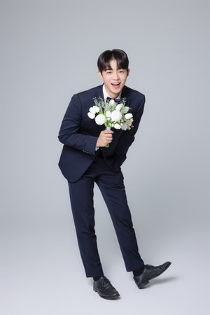 A man in his 20s wearing a suit and taking a wedding photo shootの写真素材