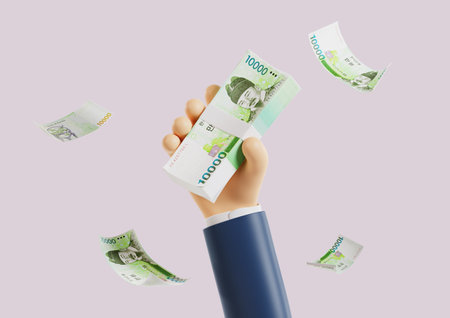 A hand holding a bundle of 10,000 wonの写真素材