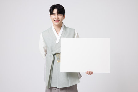 Portrait of a young man wearing hanbok and standing with copy spaceの写真素材