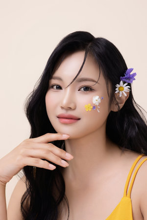 Portrait of a beautiful woman with face paint and flowers on her faceの写真素材
